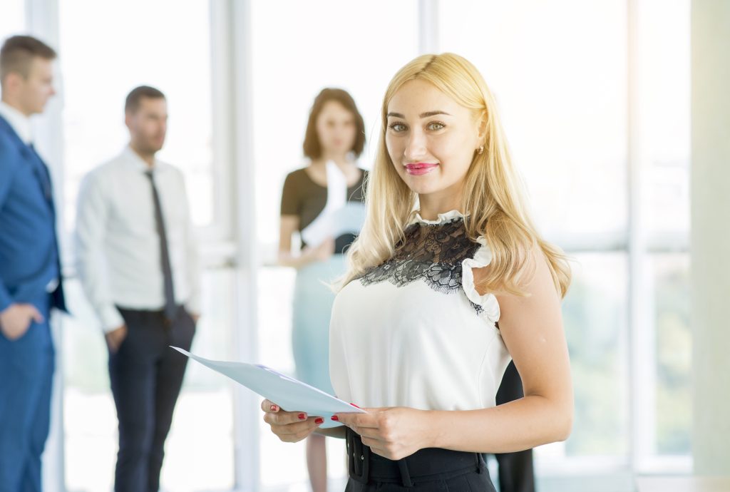 portrait smiling businesswoman holding document office